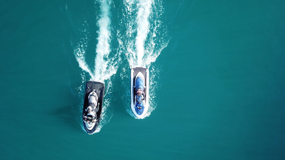 Top view of jet skis cruising in tropical sapphire clear waters